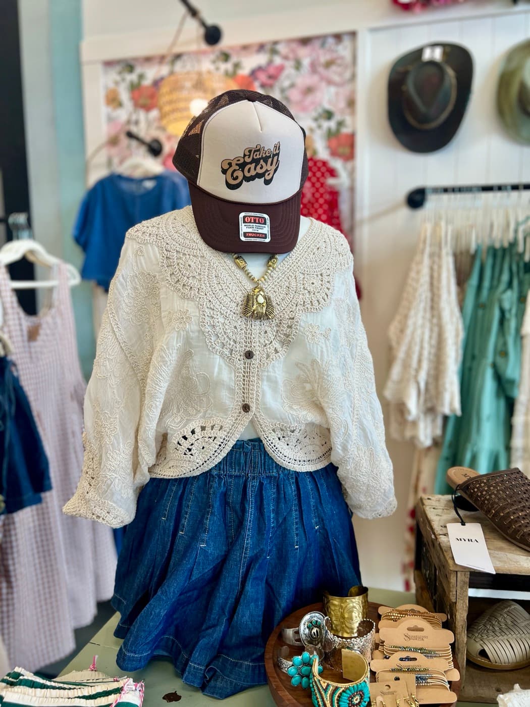 An outfit styled on a mannequin in a boutique space